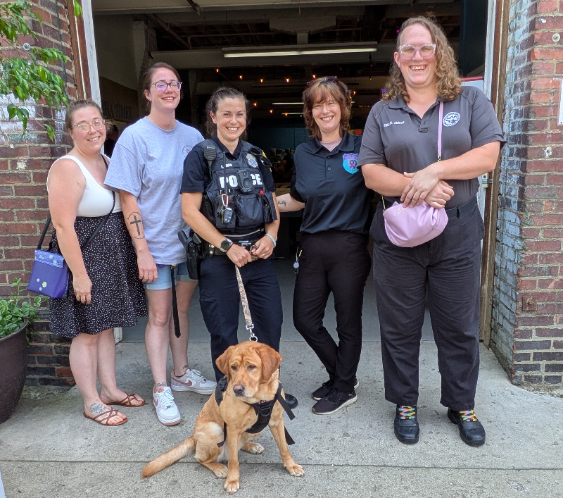 The Mental Health Association’s July picnic recovery luncheon had visitors from the Chautauqua County Coalition Against Domestic Violence & Sexual Assault. Pictured from left are YWCA Empower Her Housing Director Jacqueline Cook and Supervised Visitation and Safe Exchange Program Director Lauren Peters, Jamestown Police Department Project Crossroads Domestic Violence Officer Emma Ward and Case Manager/On-scene Advocate Allison Murphy, and City of Jamestown Department of Development Rehab and Code Enforcement Officer/Housing Court Representative Bronson Abbot. In front is Hope, JPD Project Crossroads domestic violence therapy dog.