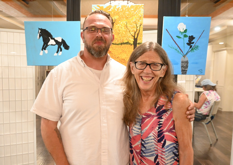 The Undercroft of St. Luke’s Episcopal Church in Jamestown was the venue for the recent Art In Recovery exhibit presented by St. Luke’s and the Mental Health Association in Chautauqua County. MHA staffer Sean Jones is pictured with Melita Lyon, one of the participating artists, standing in front of her work.