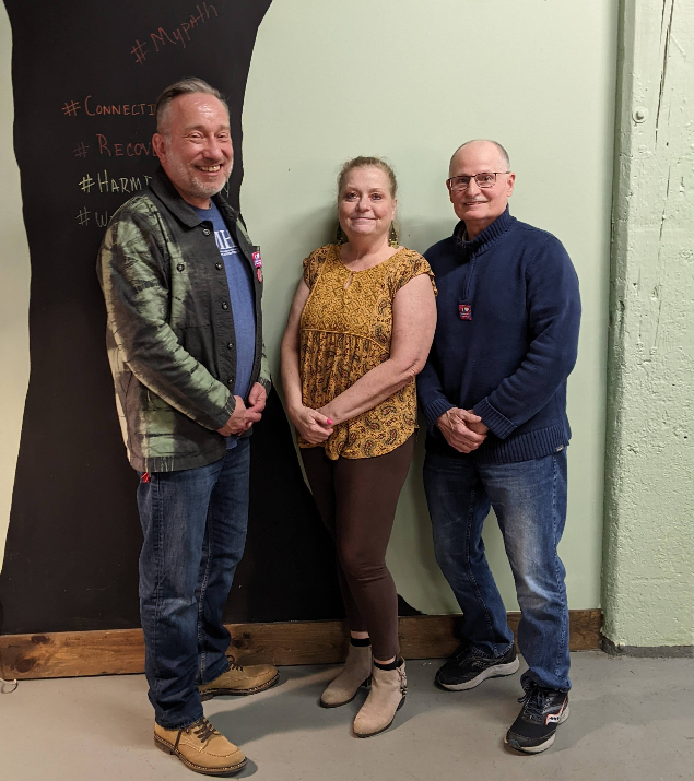 Among those recognized at the Mental Health Association April recovery luncheon by Executive Director Steven Cobb (left) were volunteers Peggy Lindsey and Tom LeBeau. The event well-attended was in the Jamestown recovery center.