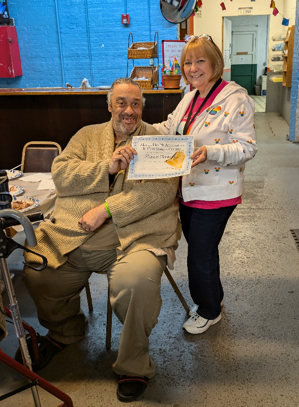 At the Mental Health Association in Chautauqua County’s August recovery luncheon, Activities Director Dianne Valvo presented participant Shawn Hastings with a certificate recognizing the great personal strides he has made and in appreciation for the makeovers he did for members of the Women’s Group. 